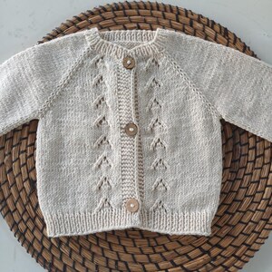 Handmade organic cotton knit baby outfit set including sweater, romper, booties, hat, and blanket. Made from 100% GOTS-certified organic cotton yarn, soft, breathable, and gentle on newborn skin. Available in multiple variations: hat and socks, hat socks cardigan, hat cardigan romper, or full 5-piece set. Custom color combinations available. Perfect for baby showers, coming-home outfits, or newborn photoshoots.