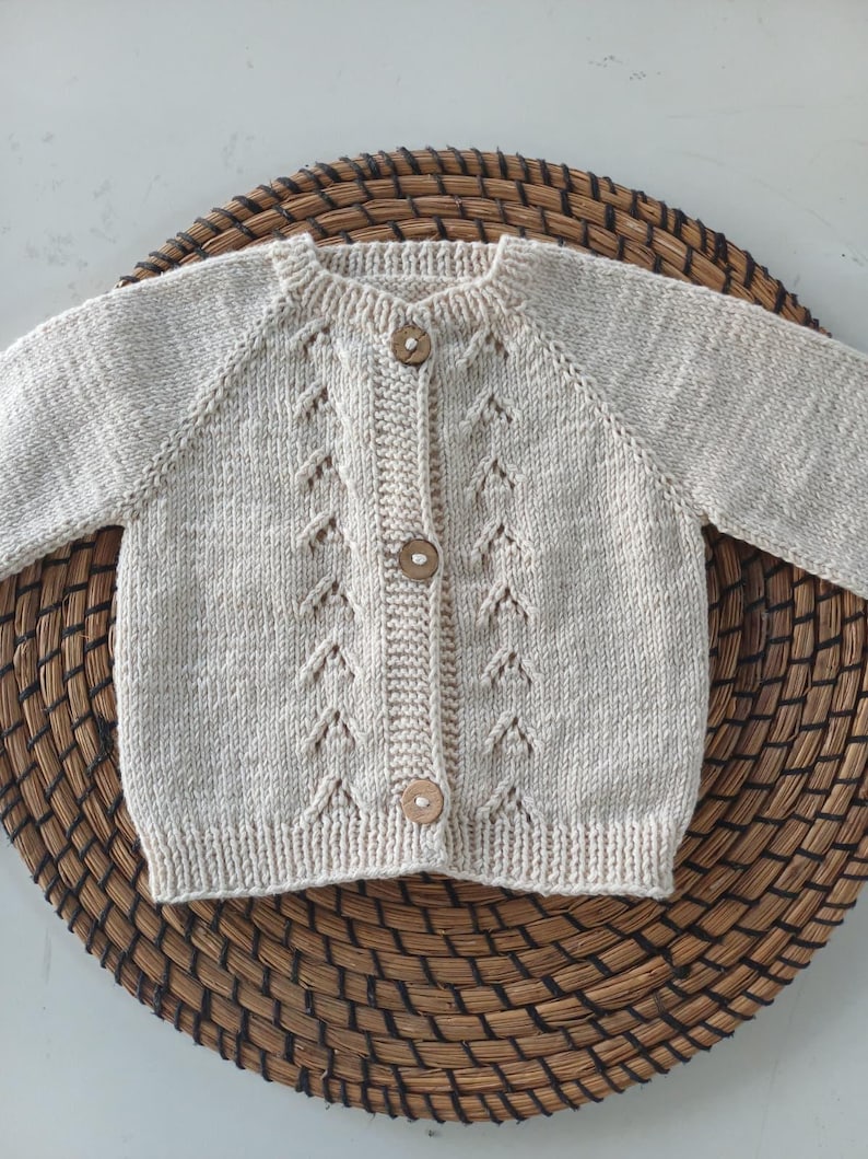 Handmade organic cotton knit baby outfit set including sweater, romper, booties, hat, and blanket. Made from 100% GOTS-certified organic cotton yarn, soft, breathable, and gentle on newborn skin. Available in multiple variations: hat and socks, hat socks cardigan, hat cardigan romper, or full 5-piece set. Custom color combinations available. Perfect for baby showers, coming-home outfits, or newborn photoshoots.