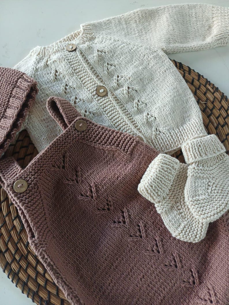 Handmade organic cotton knit baby outfit set including sweater, romper, booties, hat, and blanket. Made from 100% GOTS-certified organic cotton yarn, soft, breathable, and gentle on newborn skin. Available in multiple variations: hat and socks, hat socks cardigan, hat cardigan romper, or full 5-piece set. Custom color combinations available. Perfect for baby showers, coming-home outfits, or newborn photoshoots.