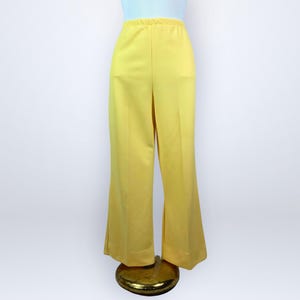 May include: A white ceramic mug with a black handle and the text "But First, Coffee" in a black, handwritten-style font. The mug is on a white surface.