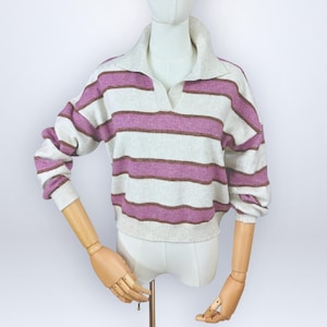 May include: A cropped sweater with a collared neckline and long sleeves. The sweater features horizontal stripes in shades of white, lavender, and brown. The garment is displayed on a mannequin.