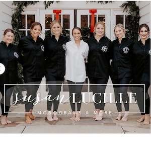 May include: Seven women wearing black long-sleeved shirts with white monograms and black leggings. They are standing in front of a white door with red bows. The text "Susan Lucille Monograms & More" is at the bottom of the image.