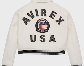 Cremefarbene Bomberjacke aus Leder von Avirex: Kurz im Varsity-Stil mit USA-Flagge