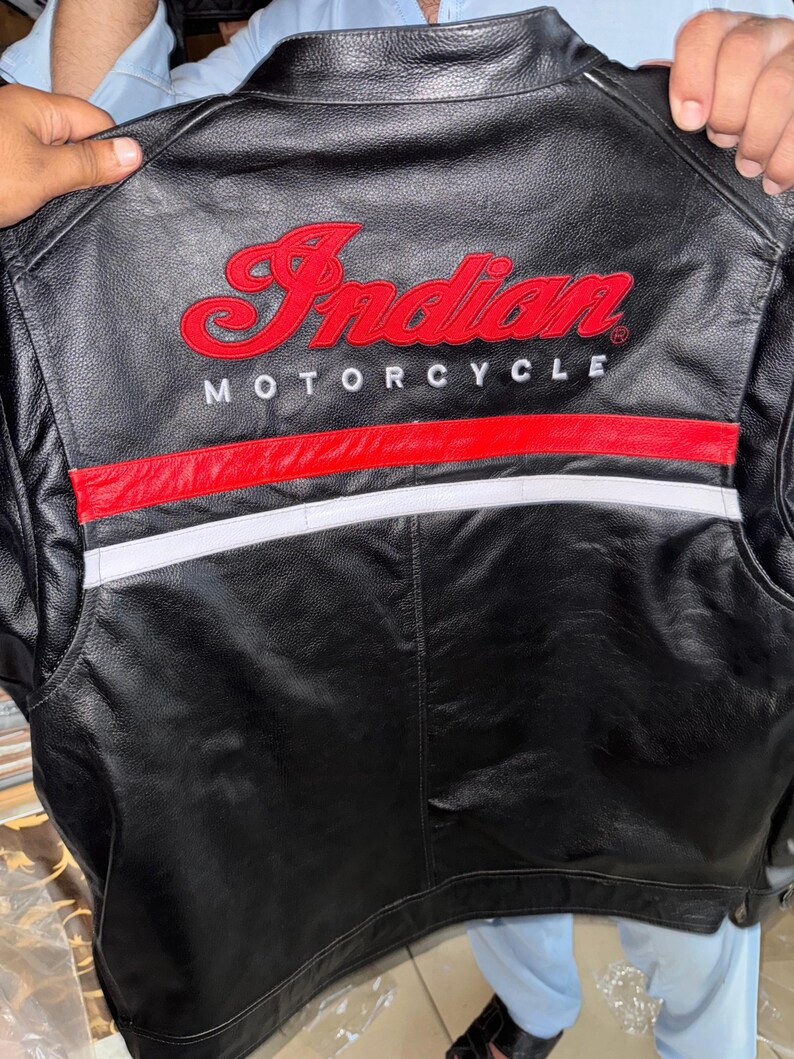 May include: Black leather motorcycle jacket with the embroidered words "Indian MOTORCYCLE" in red. The jacket has a red and white stripe design across the back.