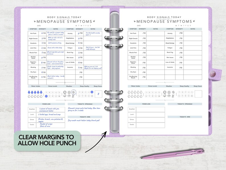May include: A lavender six-ring binder open to two pages titled Body Signals Today Menopause Symptoms. The pages feature tables for tracking symptoms, water intake, sleep, food logs, and daily struggles. A light purple pen rests below the binder.