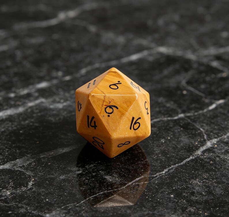 May include: A twenty-sided die crafted from smooth, golden-brown stone with visible natural veining. The die features black, hand-written style numerals including 6, 8, 14, 16, and 20 clearly etched onto its triangular faces for tabletop gaming.