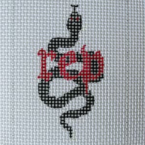 May include: Black and red snake design on white canvas. The snake is coiled and has a red heart in its coils.