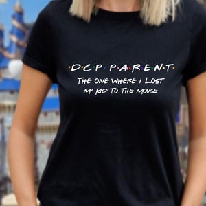 May include: Black t-shirt with white text that reads "D.C.P. PARENT. The one where I lost my kid to the mouse."