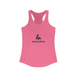 May include: A pink racerback tank top with a scoop neck and a racerback design. The tank top features a black graphic of a person working at a pottery wheel, with the text "Pottery Chick" in navy blue below the graphic.