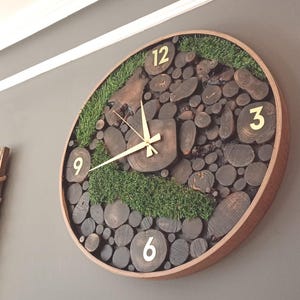 May include: A round wooden clock with a unique design. The clock face is made of wood slices and green moss. The numbers 12, 3, 6, and 9 are visible on the clock face.