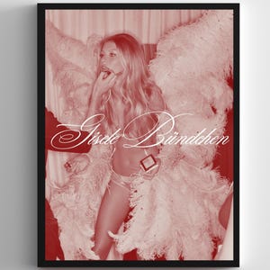 May include: A framed print featuring a woman applying makeup, wearing lingerie and large feathered wings. The image is in a sepia tone with the name "Gisele Bündchen" in cursive script.