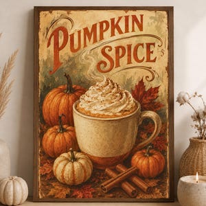 May include: A rectangular framed wall art print featuring the text PUMPKIN SPICE in large orange letters. The illustration depicts a ceramic mug filled with a beverage topped with whipped cream, surrounded by orange pumpkins and cinnamon sticks.