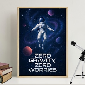 May include: A framed print depicting an astronaut in a spacesuit against a backdrop of planets and a galaxy. The image has a dark blue colour scheme, with the words "ZERO GRAVITY, ZERO WORRIES" in white. A telescope is visible in the background.