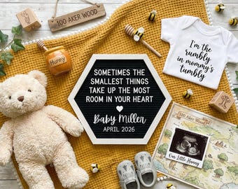 May include: A baby announcement scene with a yellow blanket, teddy bear, and a letter board that reads "Sometimes the smallest things take up the most room in your heart." Includes a baby onesie, ultrasound photo, and baby shoes.