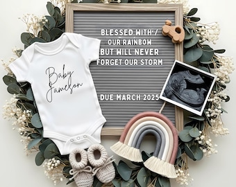 May include: A baby announcement featuring a white onesie with "Baby Jameson" in script, gray letter board with text, a sonogram, a rainbow-shaped wall hanging, and crocheted baby booties. The announcement is surrounded by greenery and white flowers.