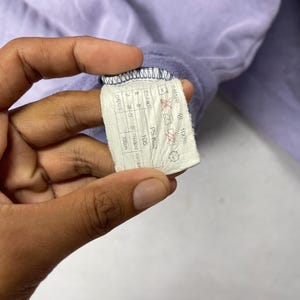 May include: A white ceramic mug with a black handle and the text "But First, Coffee" in a bold, black font. The mug is sitting on a wooden surface. The mug is approximately 4 inches tall.