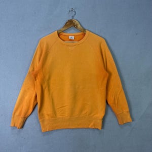 May include: A set of three ceramic mugs with a speckled, matte finish. The mugs are in shades of cream, light gray, and dark gray. Each mug has a simple, minimalist design, perfect for coffee or tea.