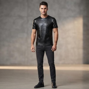 May include: A black short-sleeved t-shirt with a textured crocodile skin pattern, paired with dark gray slim-fit denim jeans and black sneakers. The t-shirt features a crew neckline and a glossy finish, while the jeans have a solid matte appearance.