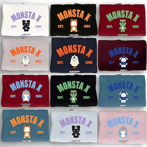 May include: A collection of twelve sweatshirts in various colors, each featuring the text MONSTA X in an arched font, the abbreviation EST., a specific year, and a unique cartoon character illustration with a name printed below it.