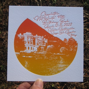 May include: A white square invitation card with an orange and yellow gradient circle design. The card features a detailed illustration of a building on a lake, with text that reads "Charlotte's 'Not Quite' 40th Birthday Bash, April 12-16, 2022, Villa Feltrinelli, Lago Di Garda, Italy" and "Save the Date."