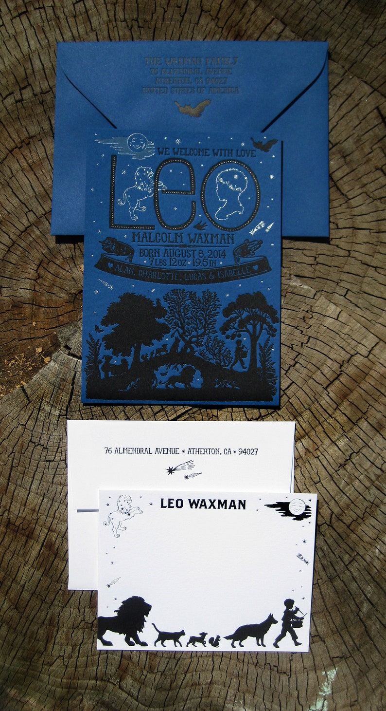 May include: A blue and black illustrated birth announcement card with the name "Leo Waxman" and the text "We welcome with love" and "Born August 8, 2014, 7 lbs 12 oz, 19.5 in". The card features a black silhouette of a forest scene with a moon and stars.