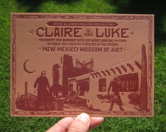 May include: A red and white wedding invitation with the text "www.claireandluke.com" at the top. The invitation announces the marriage of Claire and Luke, with the date and time of the wedding, "October 2024 at 5 o'clock in the evening", and the location, "New Mexico Museum of Art".