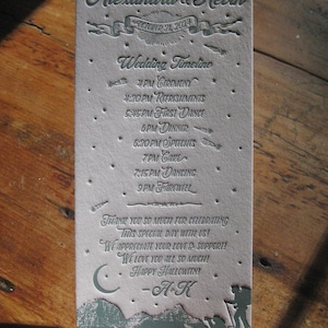 May include: A white wedding invitation with a blue and gray design. The invitation features the names Alexandra & Kevin, the date October 31, 2024, and a wedding timeline.