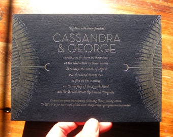 May include: Black and gold wedding invitation with a geometric design. The invitation reads "Together with their families, Cassandra & George invite you to share in their love at the celebration of their union, Saturday, the ninth of April, two thousand twenty two, at five in the evening on the rooftop of the Quirk Hotel, 201 W Bread Street, Richmond Virginia. Cocktail reception immediately following. Fancy-fouling attire. To RSVP & for more info, please visit theknor.com/georgemarruscassandra"
