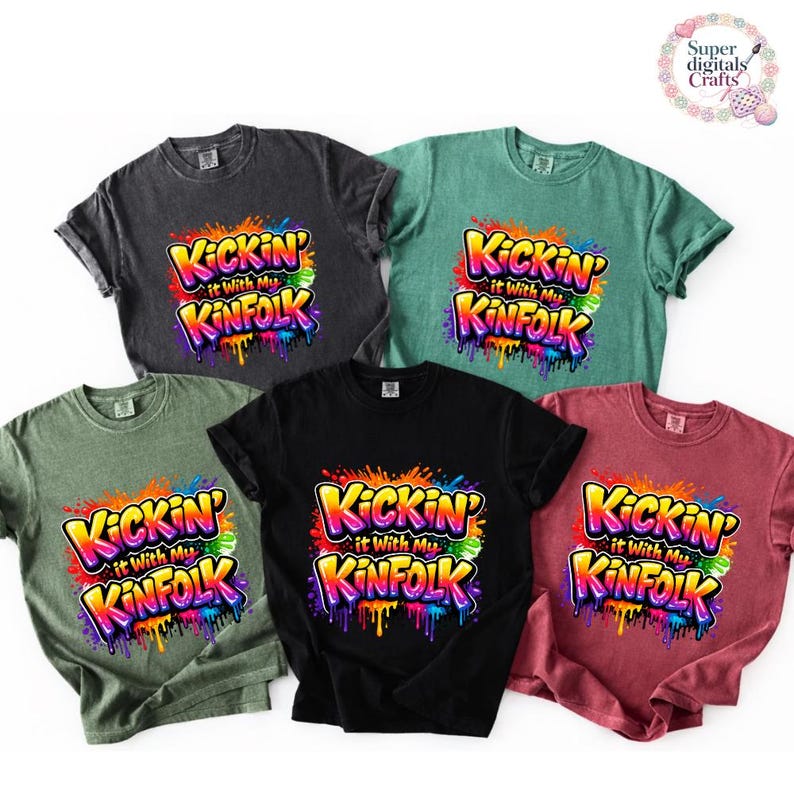 May include: Five short-sleeved t-shirts in various colors: black, dark gray, green, teal, and maroon. Each shirt features the text "Kickin' it with my Kinfolk" in a colorful, graffiti-style design.