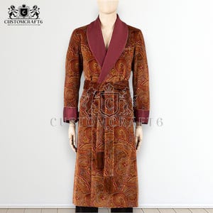 May include: A brown paisley patterned robe with a burgundy shawl collar, cuffs, and belt. The robe has a long length and a tassel on the belt. The text "CUSTOMCRAFT6" is visible on the robe.