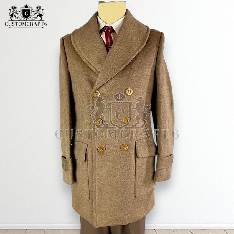 May include: A tan double-breasted overcoat with gold buttons and a wide lapel. The coat has two front pockets and a tailored fit. The brand name "CUSTOMCRAFT6" is printed on the coat. The coat is displayed on a mannequin.