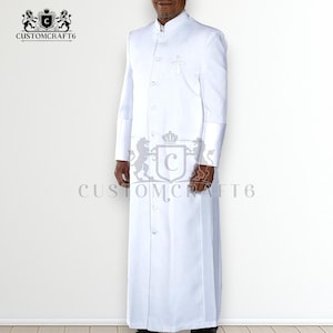 May include: A white clergy robe with a mandarin collar and a cross embroidered on the chest. The robe has long sleeves with buttoned cuffs and a button-down front. The brand name "CUSTOMCRAFT6" is printed on the image.