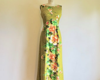 May include: A long, sleeveless maxi dress with a green background and a floral print featuring orange, pink, and white flowers. The dress has a fitted bodice and a flowing skirt.