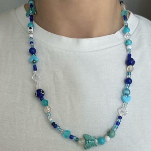 Handmade Bead women&#39;s unisex Necklace, evil eye , nazar, turquoise blue stone, flower, and heart beads, white and blue clear Beaded Necklace