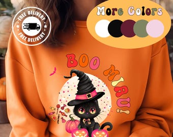 Könnte beinhalten: Orangefarbenes Sweatshirt mit einem Halloween-Motiv. Das Design zeigt eine schwarze Katze mit Hexenhut, die zwischen zwei beleuchteten Kürbissen sitzt. Der Text "BOO MIAU!" ist ebenfalls enthalten.