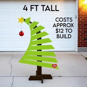 May include: A wooden Christmas tree, 1.22 metres tall, painted green with a star and ornament. The tree has a heart-shaped detail. Text on the image reads: 4 FT TALL, COSTS APPROX $12 TO BUILD.