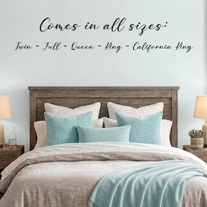 May include: A bed with a wooden headboard, featuring white and light blue pillows. A light blue blanket with fringe is draped over the bed. The text "Comes in all sizes: Twin - Full - Queen - King - California King" is written on the wall.