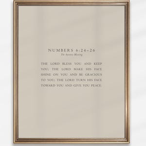May include: A framed wall art print featuring the text Numbers 6:24-26, The Aaronic Blessing, and the full verse: The Lord bless you and keep you; the Lord make his face shine on you and be gracious to you; the Lord turn his face toward you and give you peace.