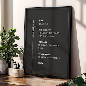May include: A black framed wall art print featuring the Serenity Prayer in white text on a dark grey background. The text reads: GOD GRANT ME THE SERENITY TO ACCEPT THE THINGS I CANNOT CHANGE; COURAGE TO CHANGE THE THINGS I CAN; AND WISDOM TO KNOW THE DIFFERENCE. AMEN.