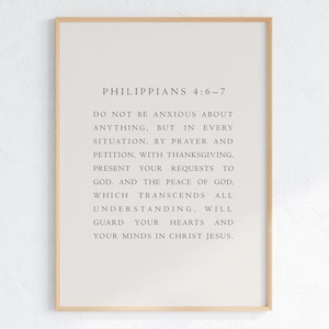 May include: A framed wall art print featuring the text of Philippians 4:6-7 in a clean, black serif font on a light beige background. The text reads: Do not be anxious about anything, but in every situation, by prayer and petition, with thanksgiving, present your requests to God. And the peace of God, which transcends all understanding, will guard your hearts and your minds in Christ Jesus.