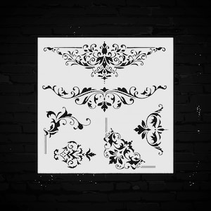 May include: A white stencil sheet featuring various black ornamental designs. The designs include floral borders, corner accents, and decorative flourishes. The stencils are ideal for crafting and decorative projects.