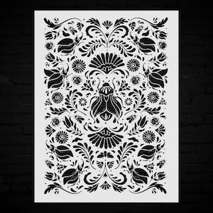 May include: A rectangular stencil featuring a black symmetrical pattern on a white background. The design consists of a central large beetle surrounded by smaller beetles, various stylized flowers, leaves, and swirling vine-like flourishes.
