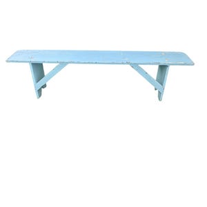 May include: A light blue, rectangular wooden bench with a distressed finish. The bench has a flat seat and angled legs for support. The bench is approximately 60 inches long.