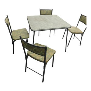 May include: A vintage dining set featuring a square table and four chairs. The table and chairs have black metal frames. The seats and table surface are covered in a green and brown patterned fabric. The table is approximately 30 inches square.