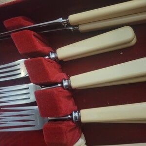 May include: Set of four silver forks with ivory handles in a red velvet lined case.