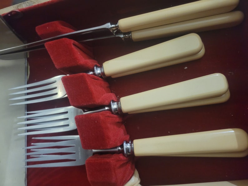 May include: Set of four silver forks with ivory handles in a red velvet lined case.