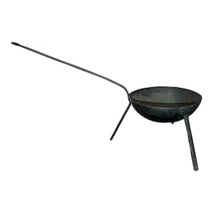 May include: A black, cast iron cooking pot with a long handle and three legs. The pot has a rounded bowl shape, perfect for open-fire cooking. The handle extends from the side, offering easy maneuverability.