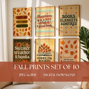 May include: A set of ten fall-themed art prints in wooden frames. The prints feature autumn leaves, cozy phrases like "Crisp Air" and "Good Books," and the text "Fall Prints Set of 10." The color palette includes orange, yellow, and brown.