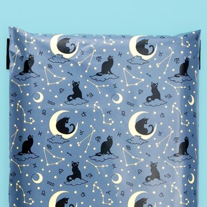 May include: A blue poly mailer with a repeating pattern of black cats, crescent moons, and constellations.