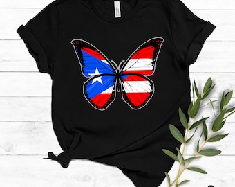May include: Black t-shirt with a butterfly design incorporating the Puerto Rican flag. The butterfly's wings are blue, white, and red, with a white star. The shirt is made of a soft material and is a digital download.